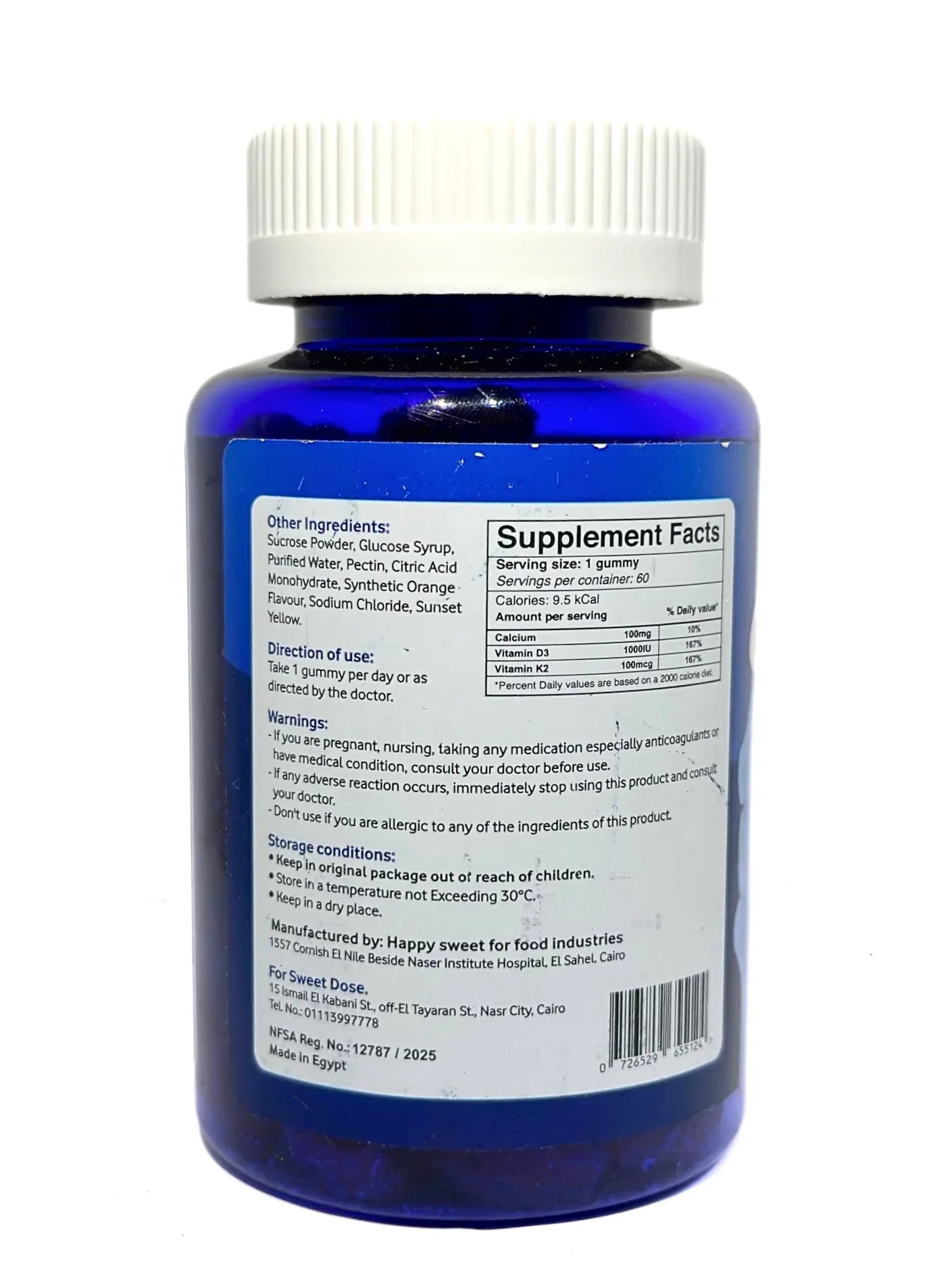 Blue supplement bottle with white cap and label on a white background